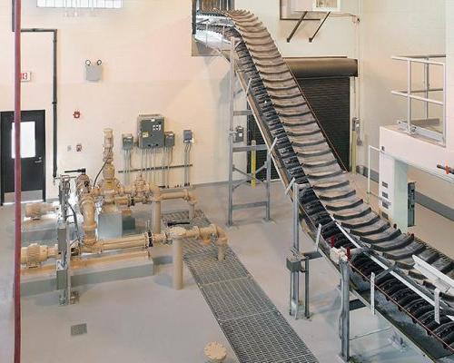 Solids conveyor system and water pipes inside the facility